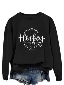 Detail of black cotton sweatshirt with white Hockey Mom graphic and ribbed cuffs