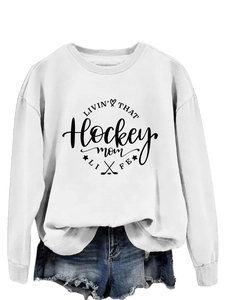 Detail of white hockey mom sweatshirt with graphic print and frayed denim shorts