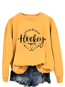Detail of yellow long sleeve hockey mom sweatshirt with graphic print and crew neck