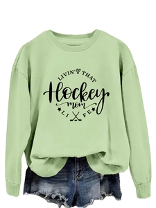 Detailed view of mint green hockey mom sweatshirt with ribbed crewneck and athletic print