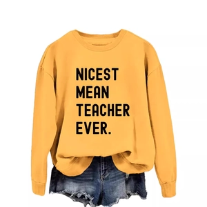 Ginger yellow Nicest Mean Teacher Ever sweatshirt with ripped denim shorts