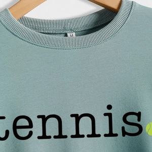 Teal green tennis sweatshirt for women with a ribbed crew neck and soft cotton fabric