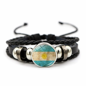 Detail of multi-layer braided leather bracelet with Argentina flag charm and metal beads