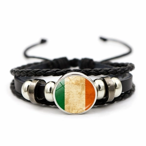 Close-up of multilayer leather woven bracelet featuring Irish flag glass pendant