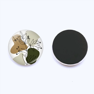 Detailed front and back view of a 25mm round glass magnet with abstract flower art line