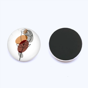 Macro detail of 30mm round fridge magnet showing abstract rose lines and magnetic back