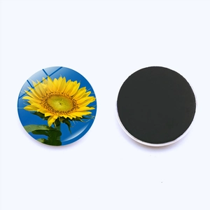 Detail of 25mm round glass sunflower fridge magnet showing front floral pattern and magnetic back