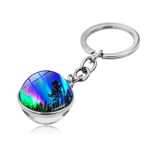 Detailed view of Aurora glass cabochon pendant on a silver metal keychain