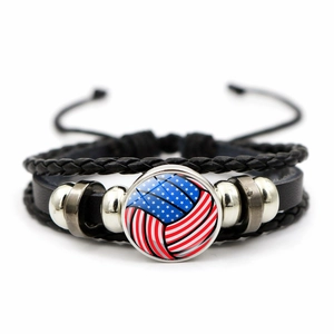 Detail of adjustable multilayer braided leather bracelet with USA flag volleyball charm