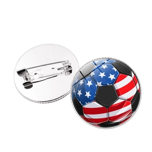 Detailed view of soccer ball brooch with US flag pattern and safety pin back