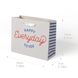 White paper gift bag with navy rainbow stripes, ribbon handles, and Everyday Happy text