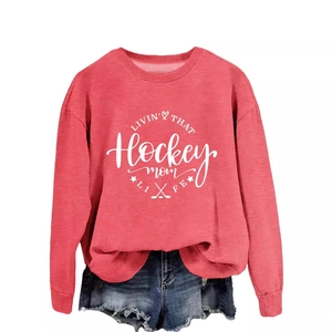Red Hockey Mom long sleeve sweatshirt with heart graphic and distressed denim shorts