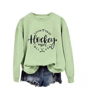 Sage green long sleeve hockey mom sweatshirt with graphic print and denim shorts