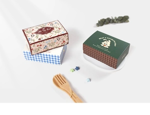 Detail of square gift boxes with vintage floral patterns and cute cartoon rabbit designs
