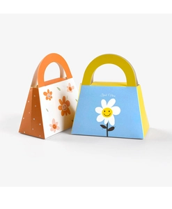 Detail of portable gift boxes with floral smile patterns and Good Vibes typography