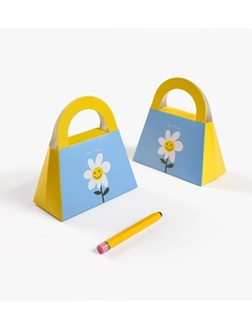 Detail of blue and yellow Good Vibes candy gift bags with daisy print and handle