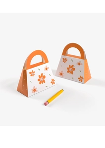 Detail of small trapezoid gift bags with orange sunflower prints and smiley faces