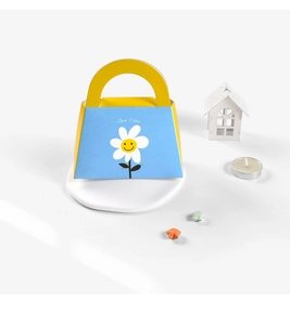 Detail of blue and yellow gift box with Daisy Good Vibes print for wedding favors