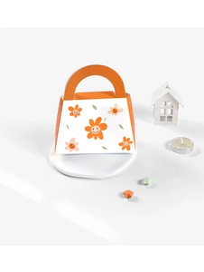 Macro shot of orange and white flower patterned gift box with a small handle