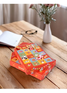 Detail of red Christmas advent calendar with 24 grids and festive cartoon character toys