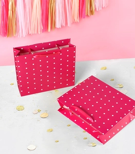 Detailed view of rose red polka dot gift bag with matching silk handles for birthday