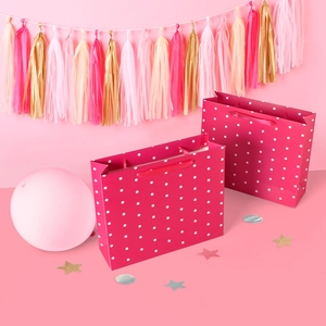 Rose pink polka dot gift bags with satin handles for birthdays and festive parties