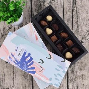 Detail view of 10-piece artisan chocolate gift box with colorful graffiti lid and merci tag