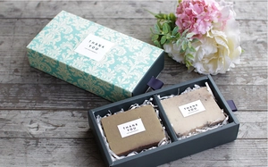 Detail of drawer-style handmade soap gift box with two soap bars and damask pattern