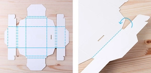 Flat template of white paper gift box showing folding lines and assembly instructions