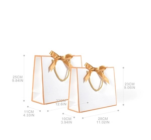 Size comparison for white luxury paper gift bags with orange trim and golden ribbons