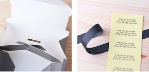 Detail of sliding rectangular gift box with grey ribbon and assembly manual guide