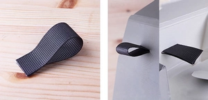 Macro detail of black ribbed ribbon handle on a matte grey folding gift paper box