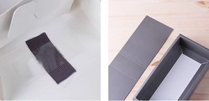 Detail view of a square drawer-style grey cardboard tea gift box with a white interior liner