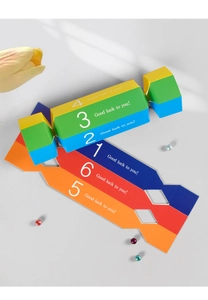 Macro detail of colorful candy-shaped paper wedding favor boxes with Good Luck text