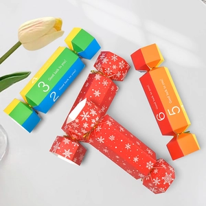 Rainbow and red candy-shaped paper gift boxes with snowflakes and Good Luck text
