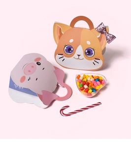 Detail of portable cartoon animal candy gift boxes in cat and pink pig shapes