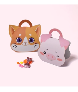 Close-up of cute foldable cat and pig paper gift boxes for candy packaging on pink background