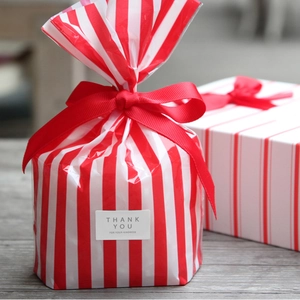 Red and white striped gift bags and boxes with red bows and Thank You stickers