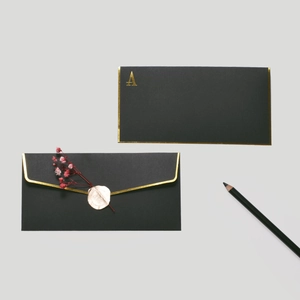 Elegant black and gold greeting card set with wax seal and dried flower accents