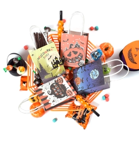 Mini Halloween gift bags in orange basket featuring four festive themed party designs