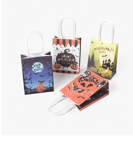 Detail of four colorful Halloween paper gift bags with white twisted handles for parties