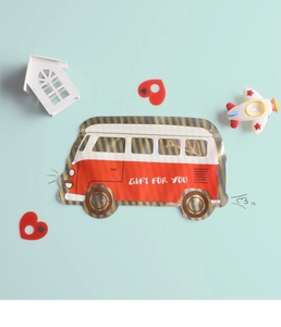 Close-up of vintage bus-shaped gift bags with red and white patterns in a playful scene