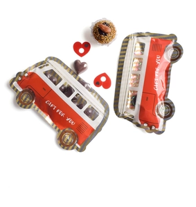 Macro detail of red bus-shaped self-sealing gift bag with a clear window for sweets