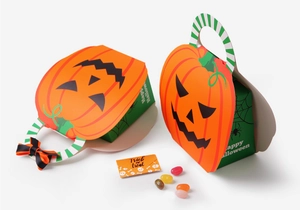 Detail of pumpkin-shaped Halloween gift box with Happy Halloween and Trick or Treat prints