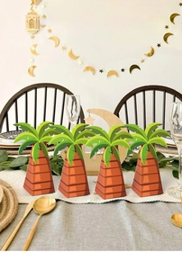 Macro detail of palm tree shaped party favor boxes on a tropical theme table setting