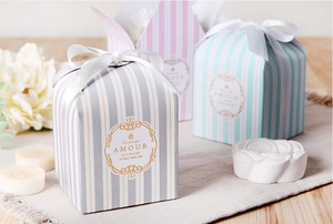Macro detail of square striped gift boxes with satin bows and elegant labels