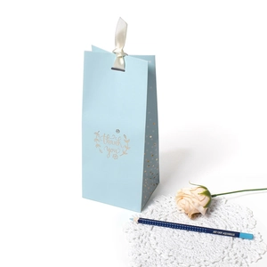 Blue business gift bag with gold thank you lettering and cream white satin ribbon bow