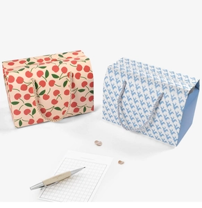 Detail of portable gift boxes with cherry print and blue patterns for cake packaging