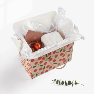 Elegant gift box with cherry print, braided handles, and candy jar inside for snacks