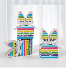 Macro detail of rainbow striped rabbit ear gift boxes with white satin bows